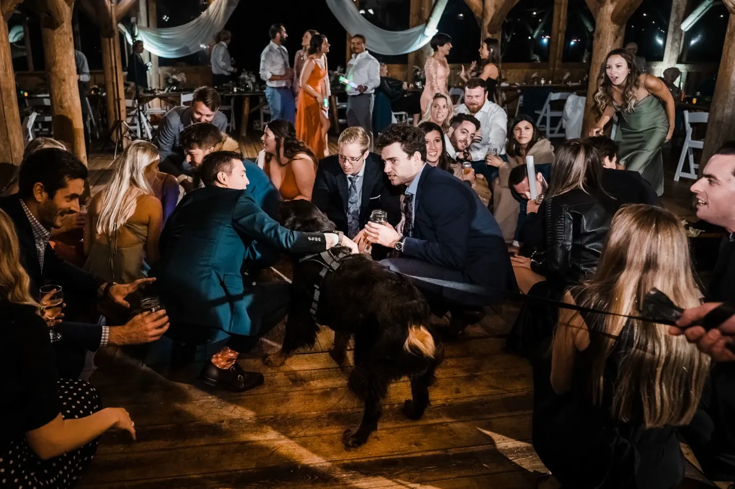Wedding guests dancing and celebrating during lively reception party with DJ music