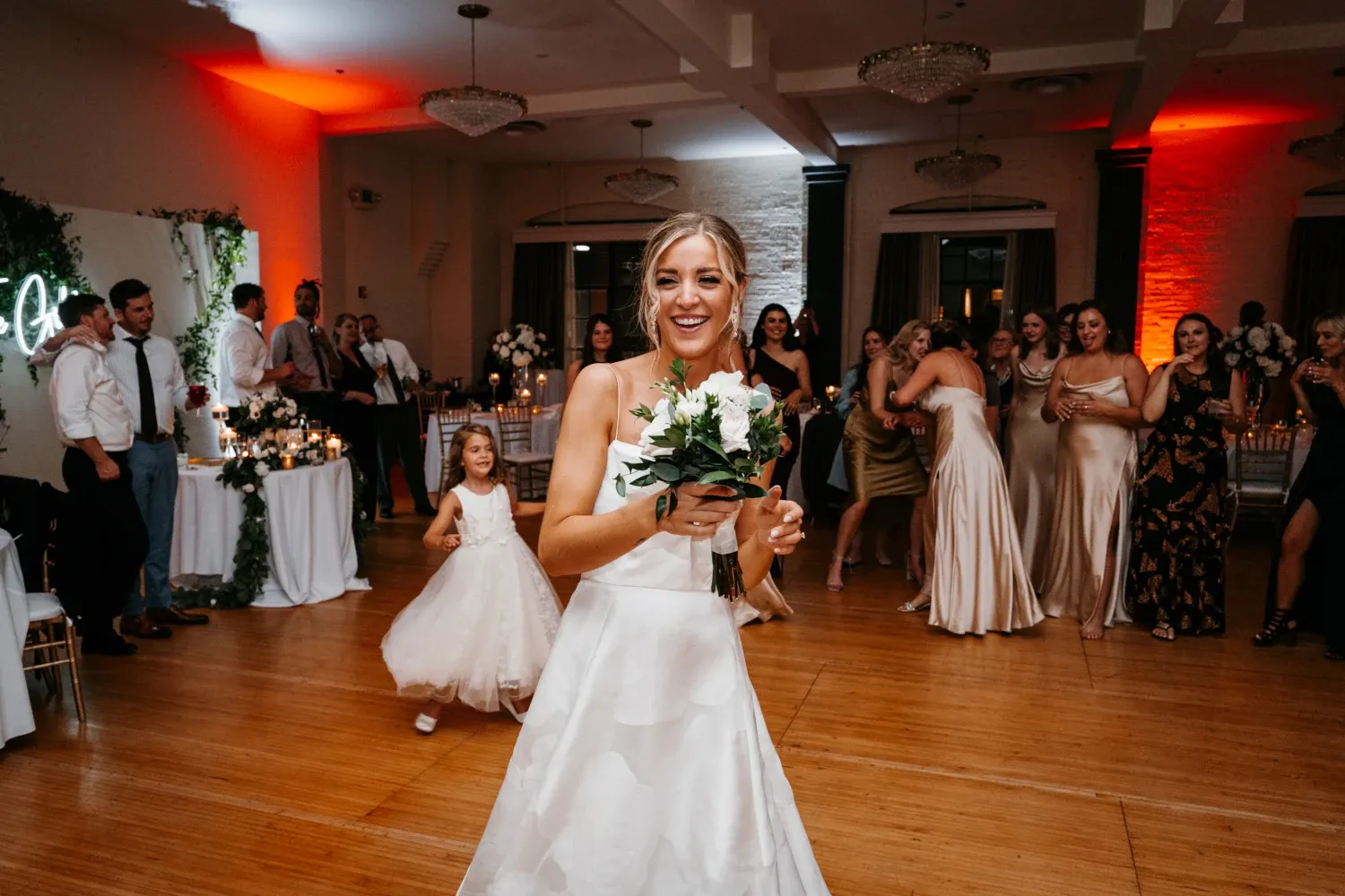 Bride smiling on dance floor during elegant wedding reception celebration